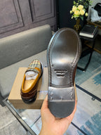 Burberry loafer sole view, dark rubber outsole and stitched heel edge