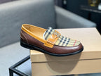 Burberry loafer side view, tan leather and plaid panel with dark rubber sole