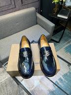 Burberry navy patent leather loafers with TB buckle detail, front view
