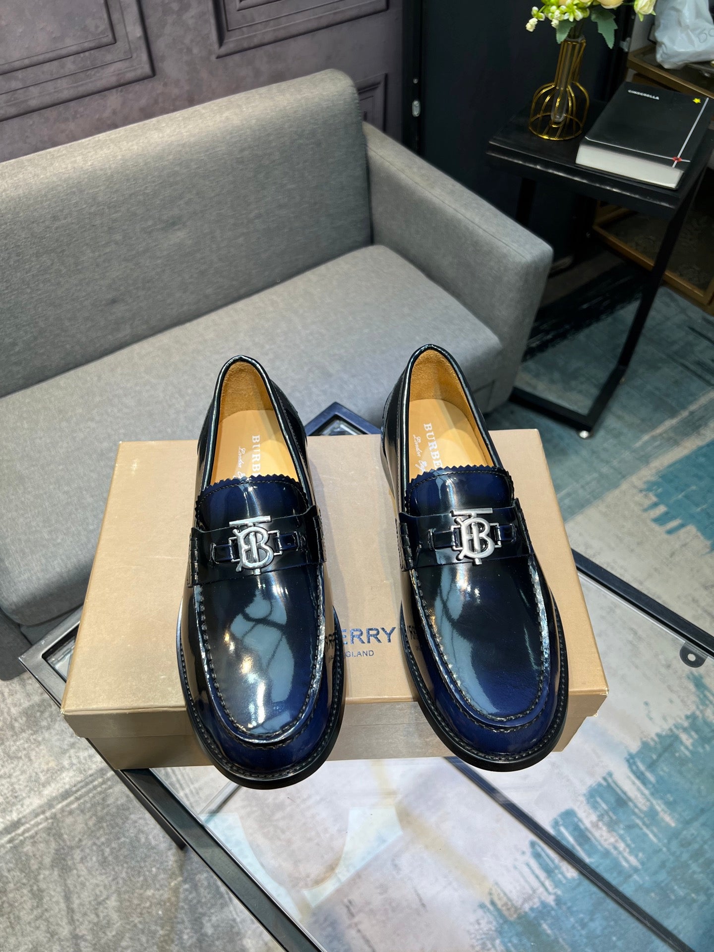 Burberry navy patent leather loafers with TB buckle detail, front view