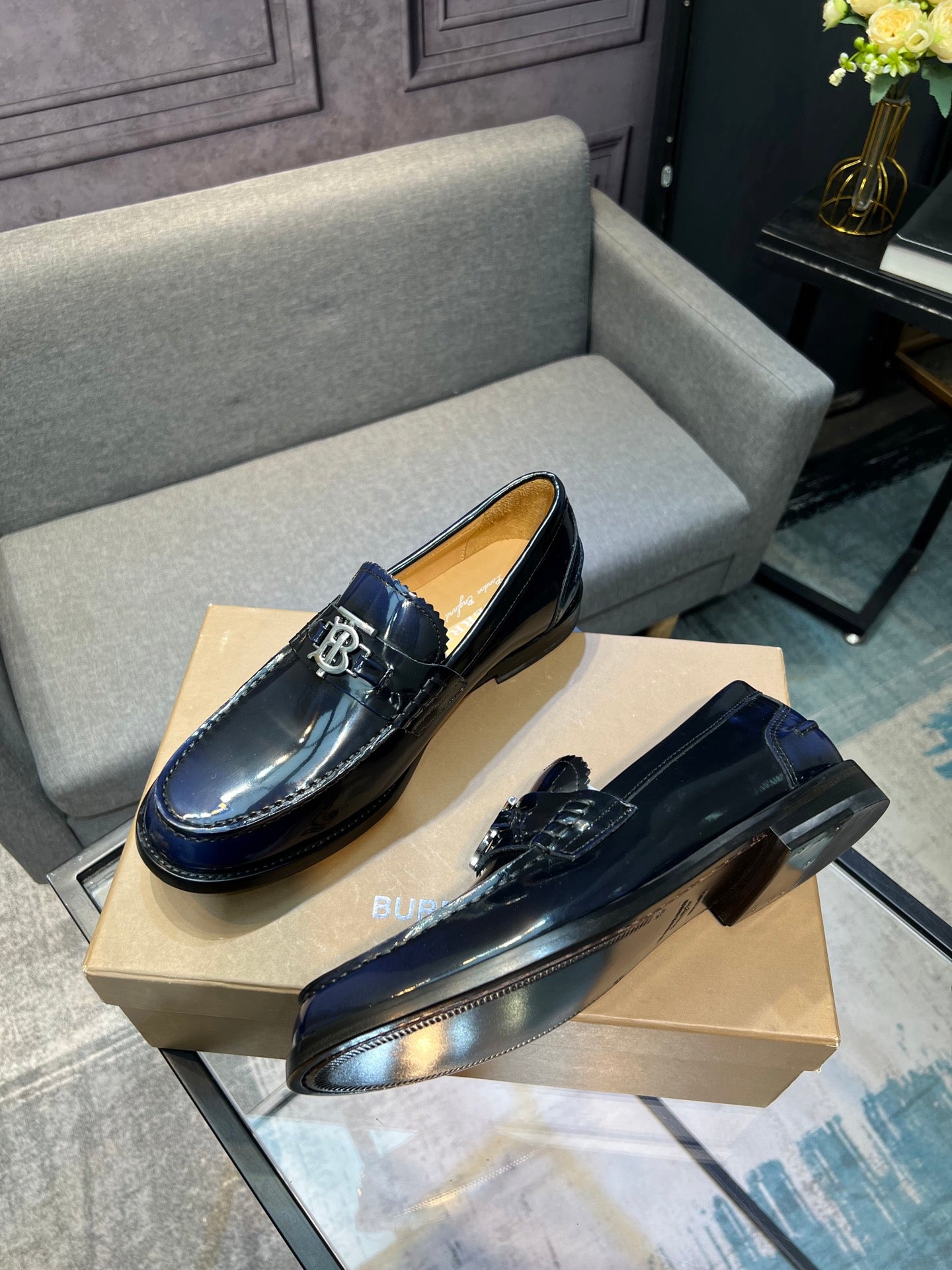 Burberry navy patent leather loafers with TB buckle detail, side view