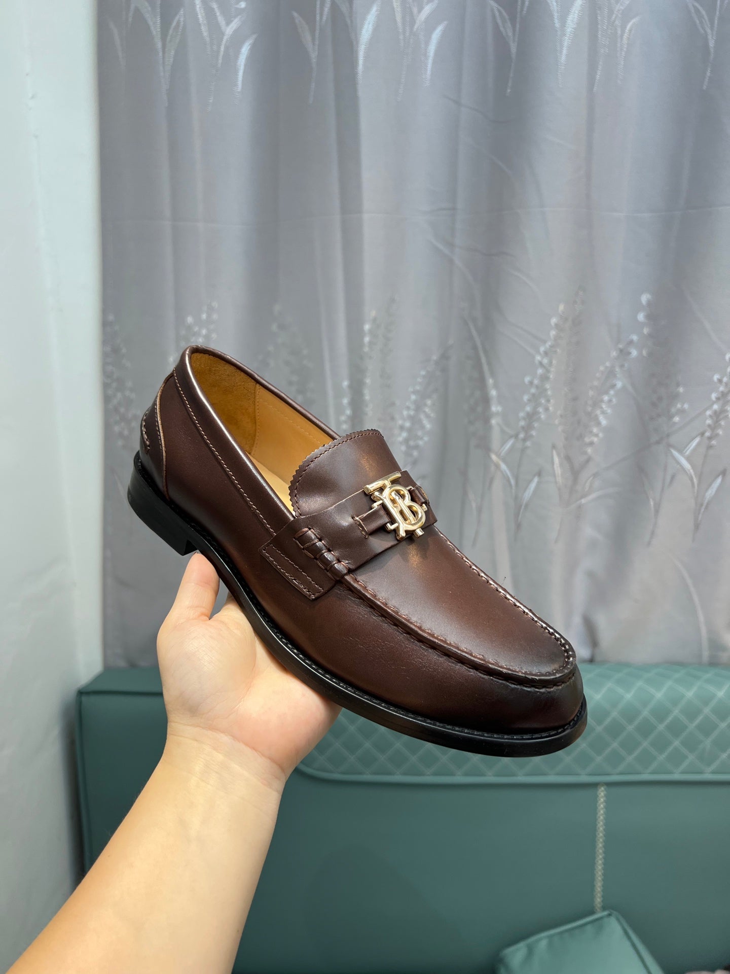 Brown leather loafer with metal TB buckle and black rubber sole