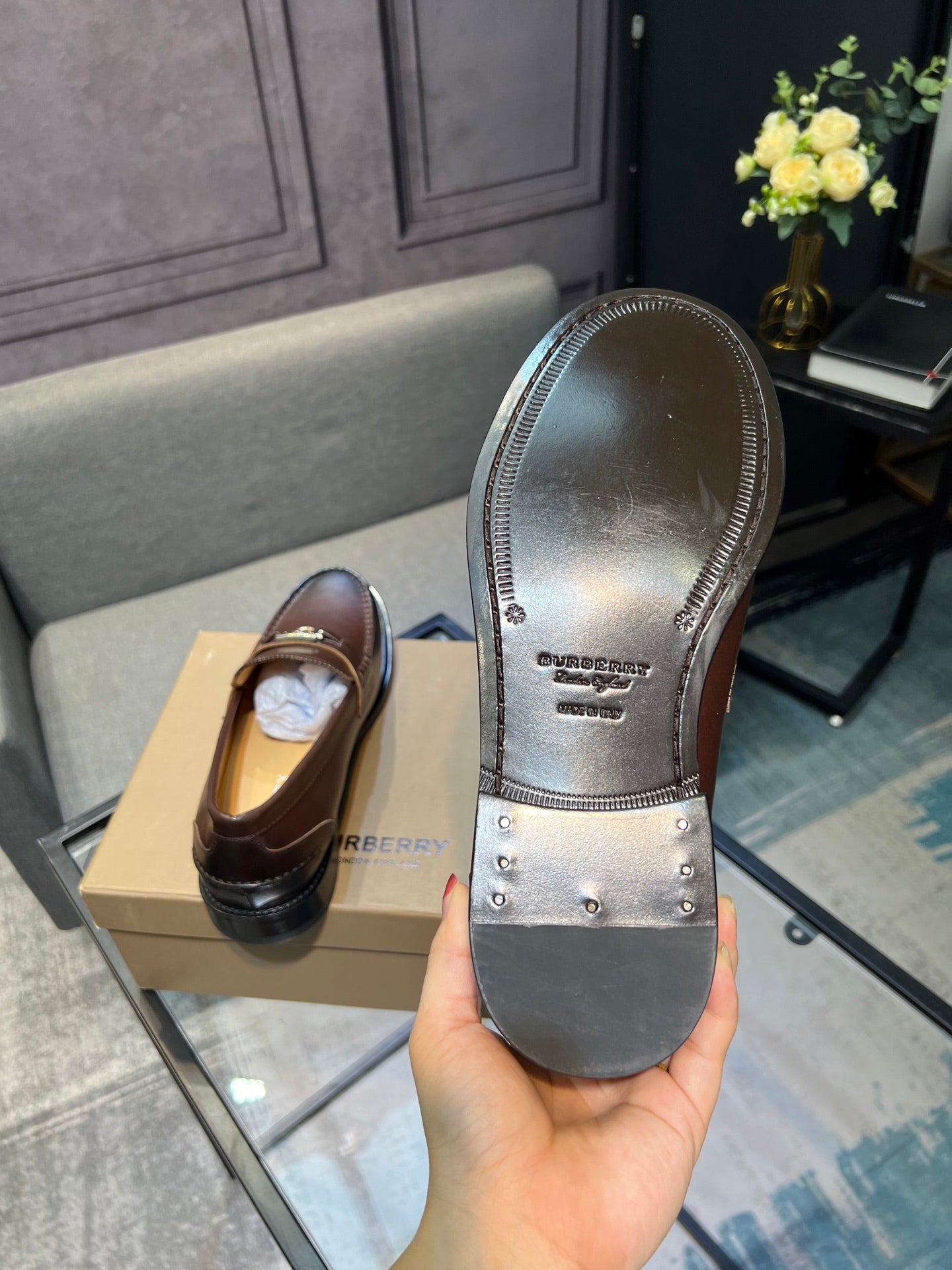 Brown leather loafer showing underside with treaded black sole