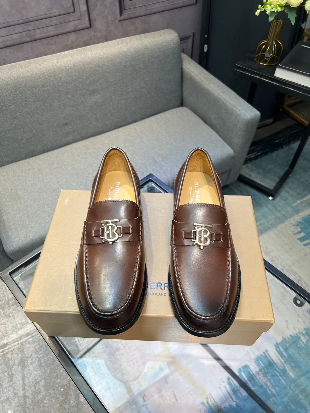 Brown leather loafer shoes with metal TB buckle and black rubber sole