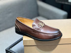Brown leather loafer with metal TB buckle and black rubber sole, side view