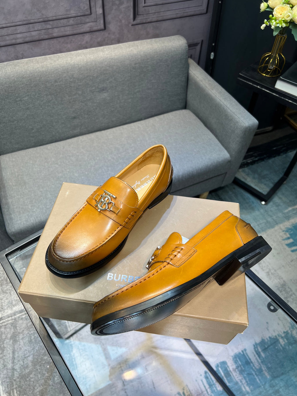 Burberry leather loafers, tan, angled view with TB metal bit detail