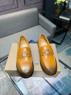 Burberry tan leather loafers pair with TB metal bit and dark rubber sole