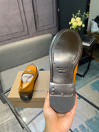 Burberry loafer outsoles, dark rubber with raised tread and brand text