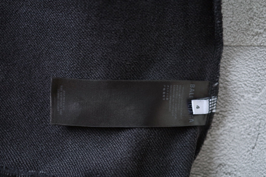 Charcoal gray fabric label and brand tag at hoodie cuff