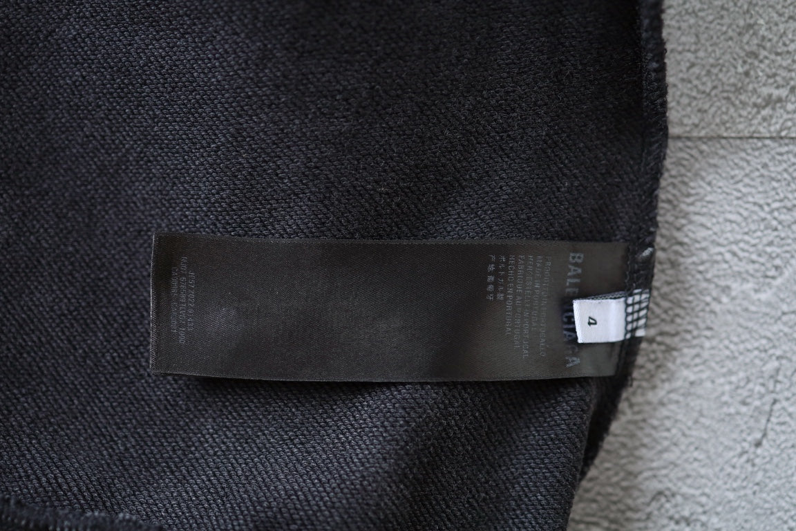 Charcoal gray fabric label and brand tag at hoodie cuff
