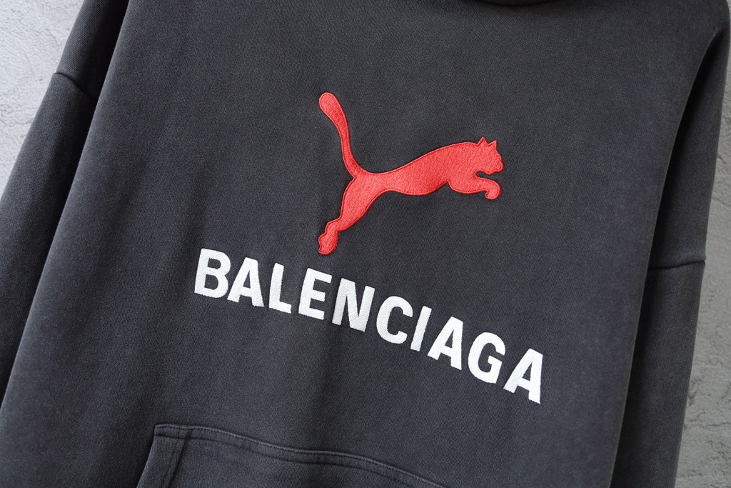 Charcoal gray Balenciaga hoodie sweatshirt with red puma logo and white lettering