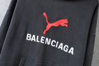 Charcoal gray Balenciaga hoodie sweatshirt with red puma logo and white lettering