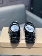 Black leather loafer shoes, back view showing heel and low profile