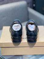 Burberry dark leather loafers with stitching, back view on box