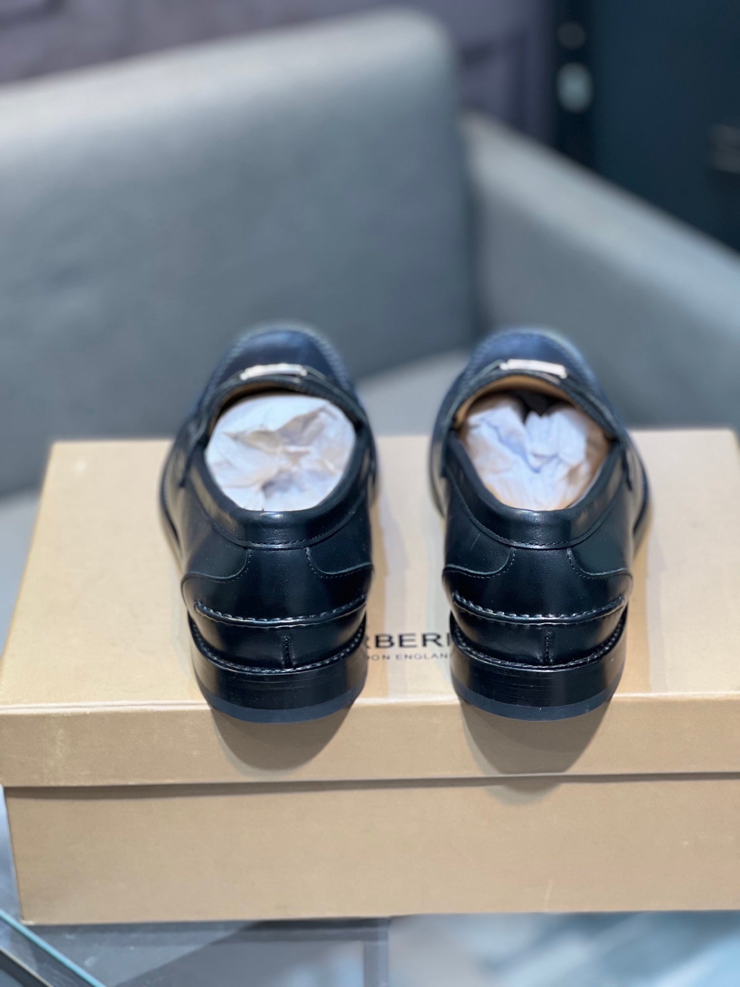 Burberry dark leather loafers with stitching, back view on box