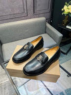 Burberry dark leather loafers with metal buckle, side angle pair on box