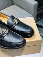 Burberry dark leather loafer with metal buckle, close-up on box