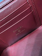 Dark red leather bag interior card holder with CHANEL and MADE IN ITALY embossed.