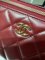 Quilted dark red leather flap with gold-tone CC emblem and stitch detailing.