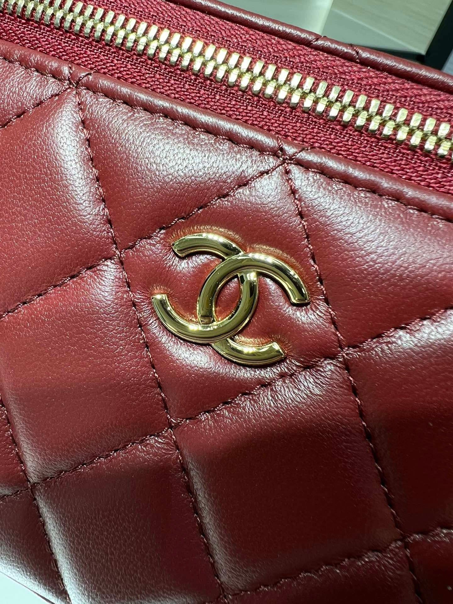 Quilted dark red leather flap with gold-tone CC emblem and stitch detailing.