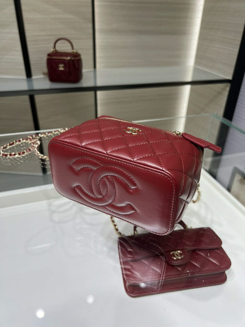 Dark red quilted crossbody bag with flap, gold-tone CC emblem, and chain strap.