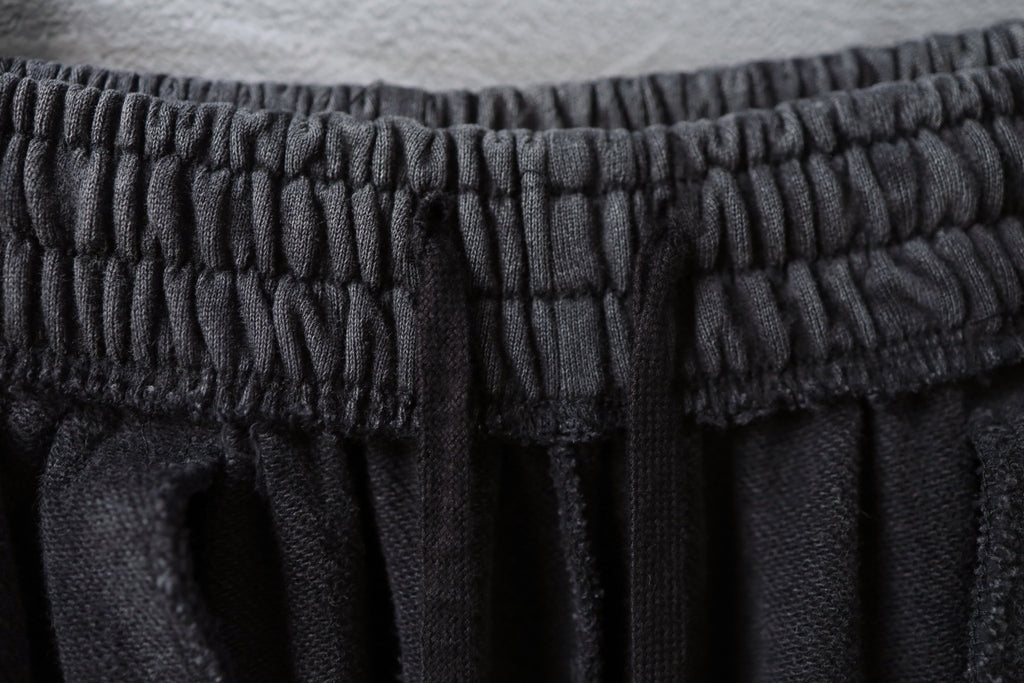 Textured elastic waistband on dark gray pants