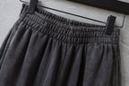 Balenciaga pants elastic waistband with gathered pleats, hanging on hanger.