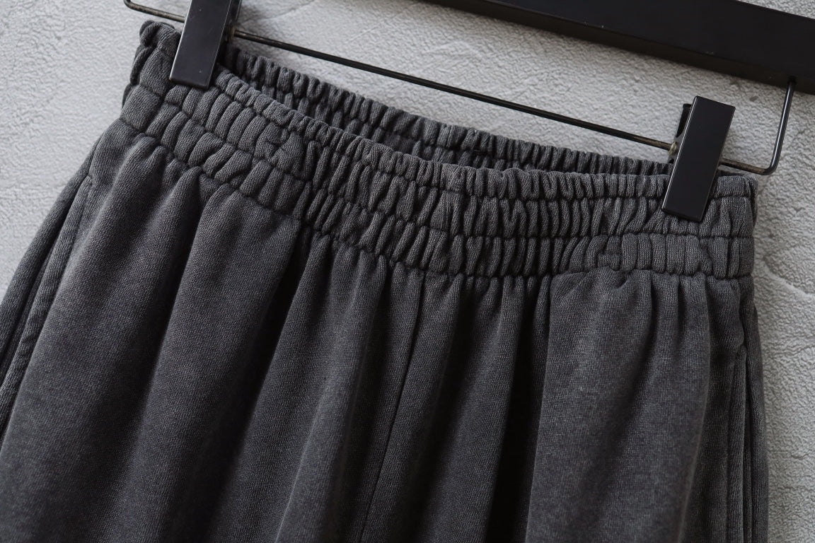 Balenciaga pants elastic waistband with gathered pleats, hanging on hanger.
