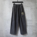 Dark gray wide-leg pants with elastic waistband and Balenciaga logo patch
