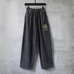 Dark gray wide-leg pants with elastic waistband and Balenciaga logo patch