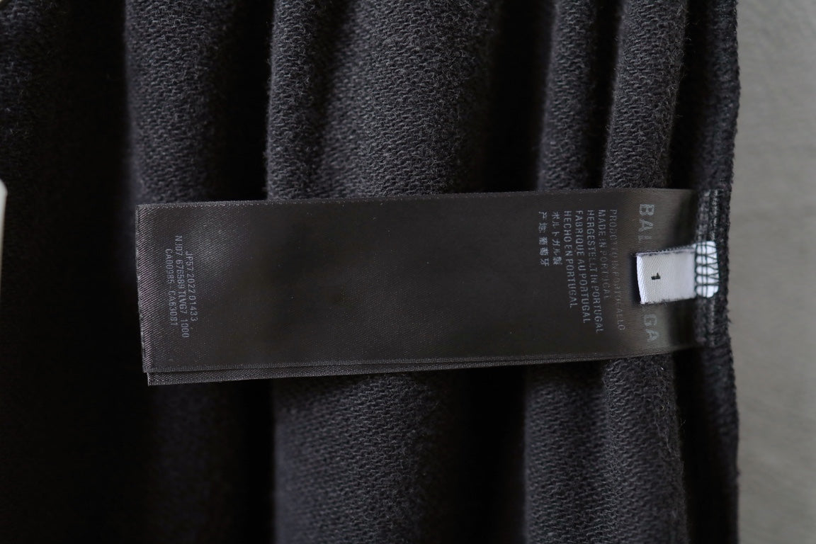Balenciaga pants with fabric label attached near waistband seam.