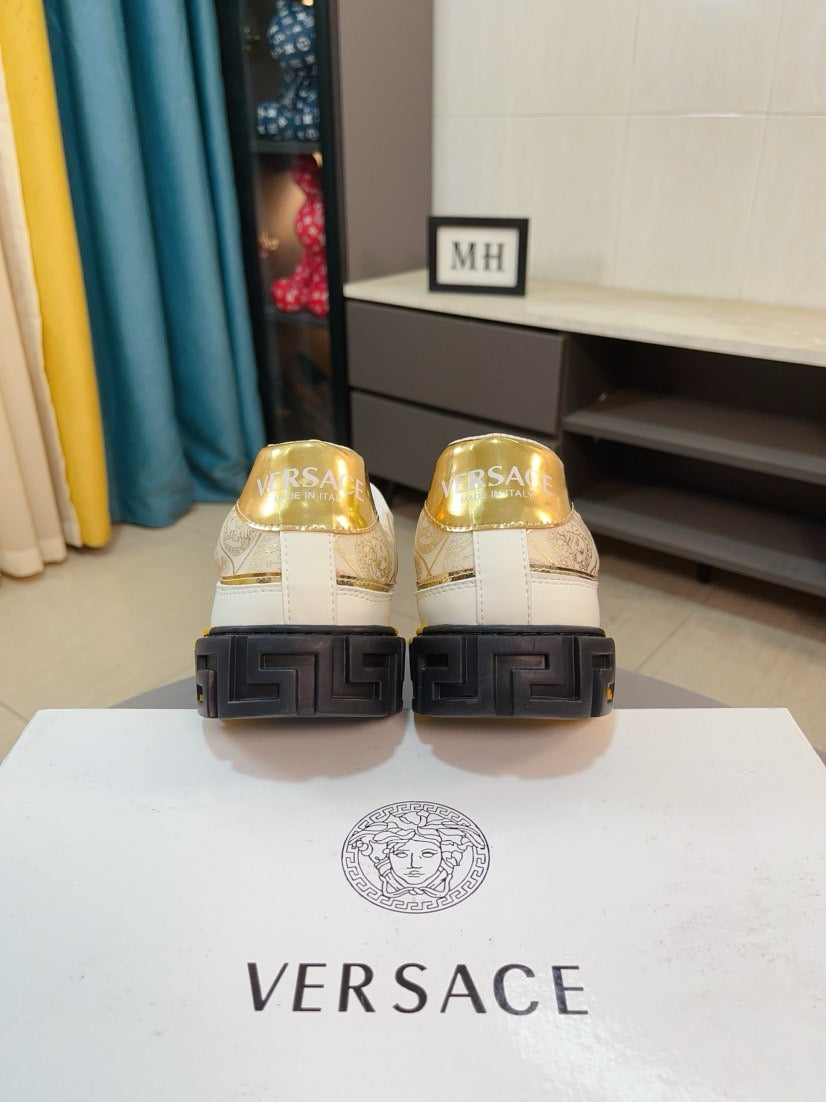 Back view of white and gold sneakers with textured black heel sole