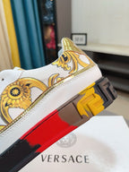 White luxury sneakers close-up of heel with gold print and textured platform outsole.