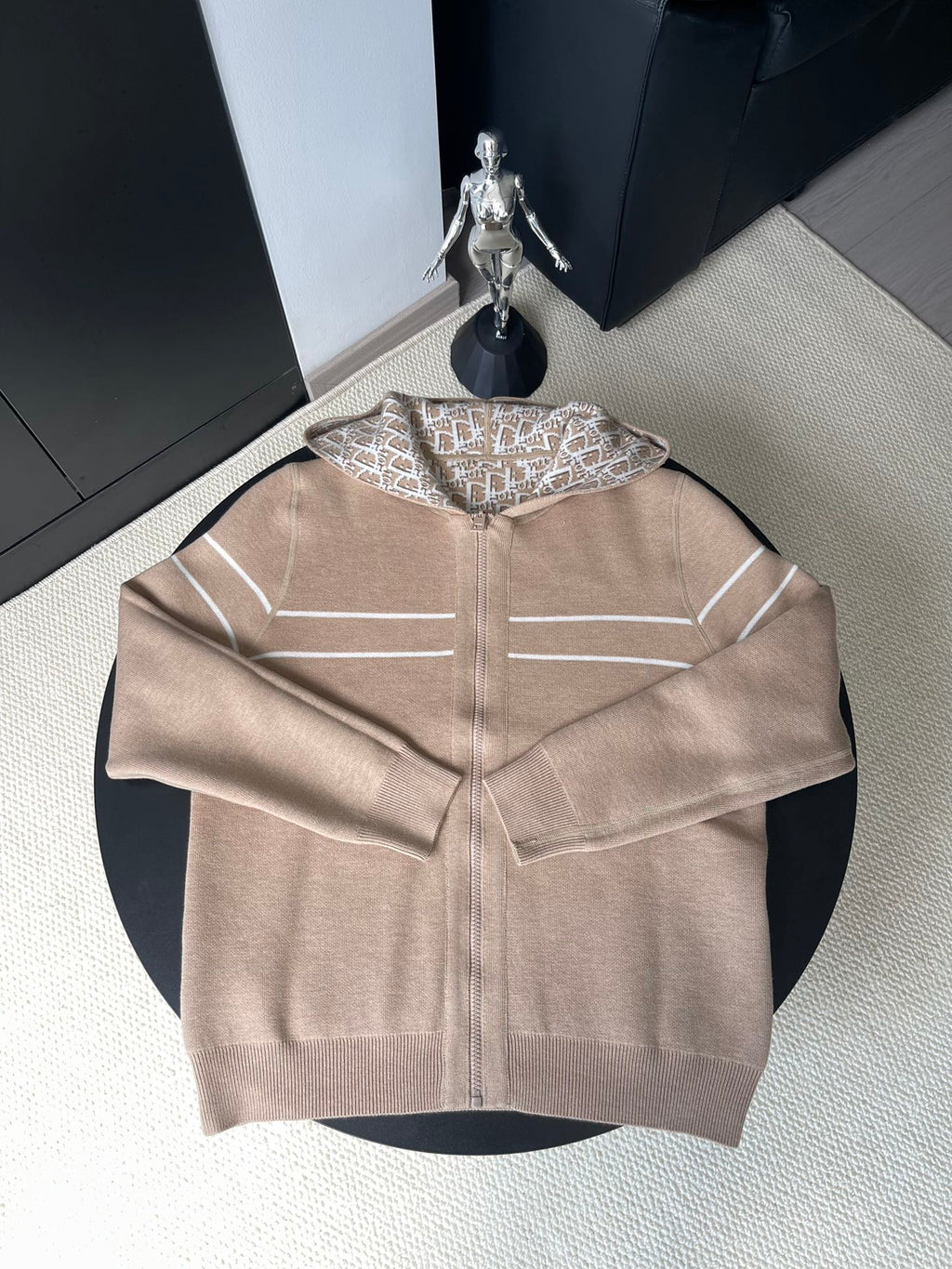 Beige zip-up hooded jacket with geometric logo lining, front zipper and side pockets