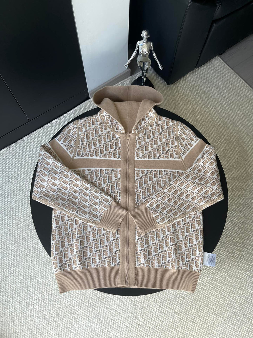 Beige hooded jacket with all-over geometric logo pattern and front zip