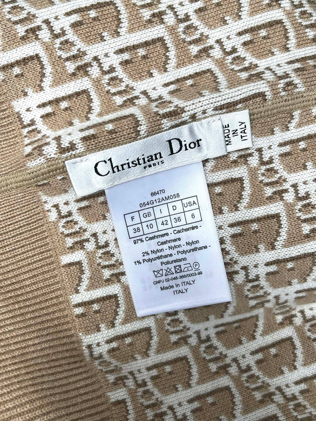Clothing label inside beige hooded jacket with size and fabric details