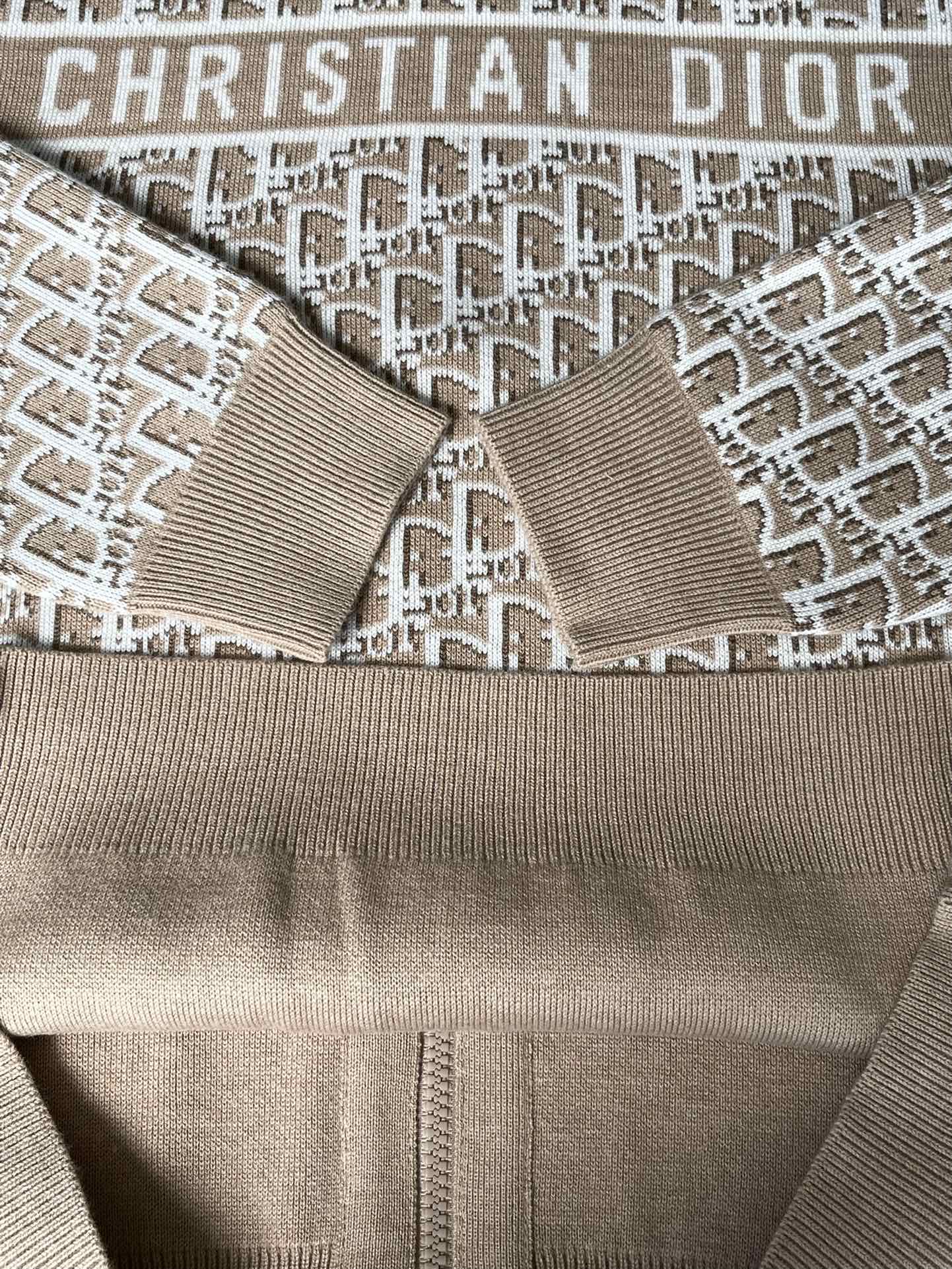 Close-up of beige hooded jacket with all-over Christian Dior logo pattern