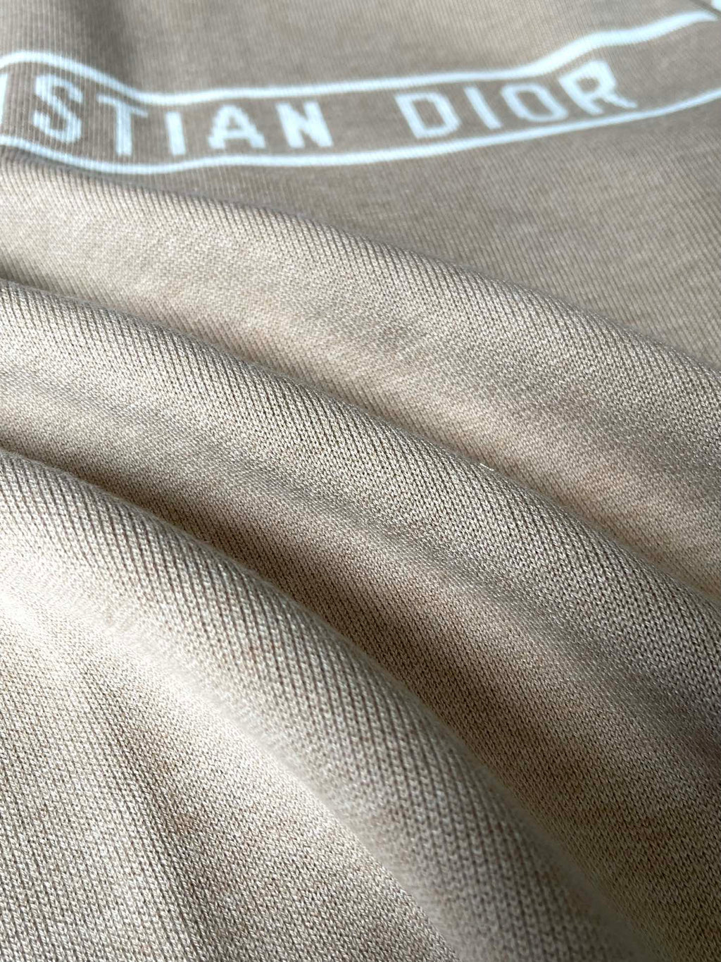 Beige ribbed cuffs and hem detail on a zip-up hooded jacket