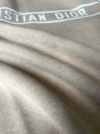 Beige ribbed cuffs and hem detail on a zip-up hooded jacket