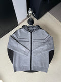 Gray hooded zip-up sweater with black zipper and stitched chest pockets