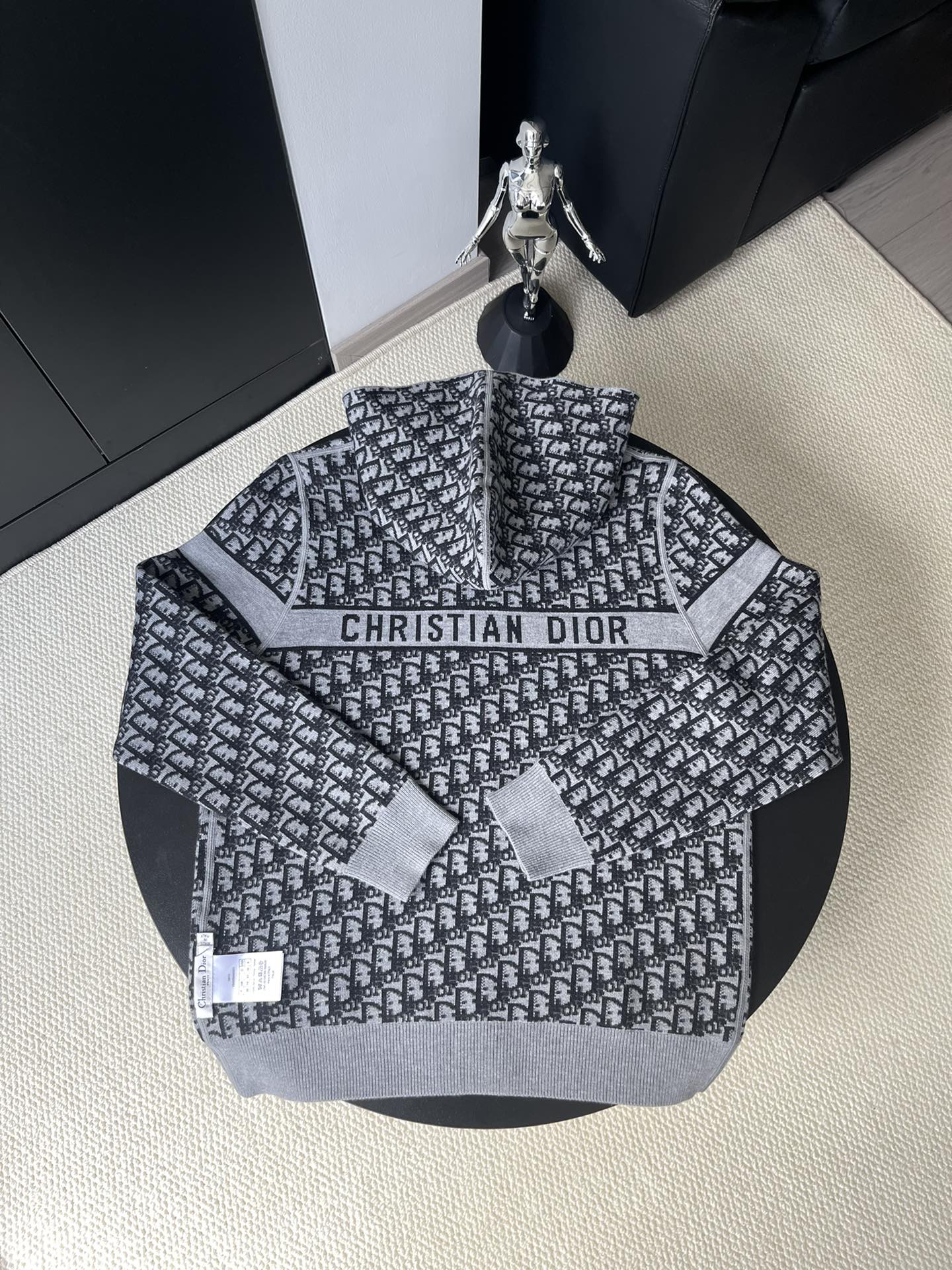 Black and gray patterned hooded zip-up sweater back with “CHRISTIAN DIOR” logo