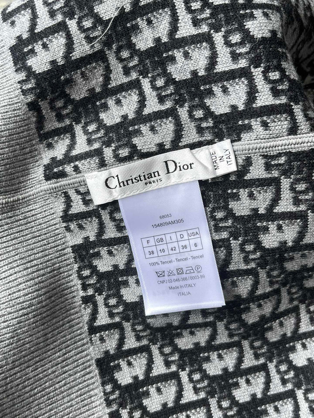 Inside neck tag with “Christian Dior” text and size/care label on patterned knit