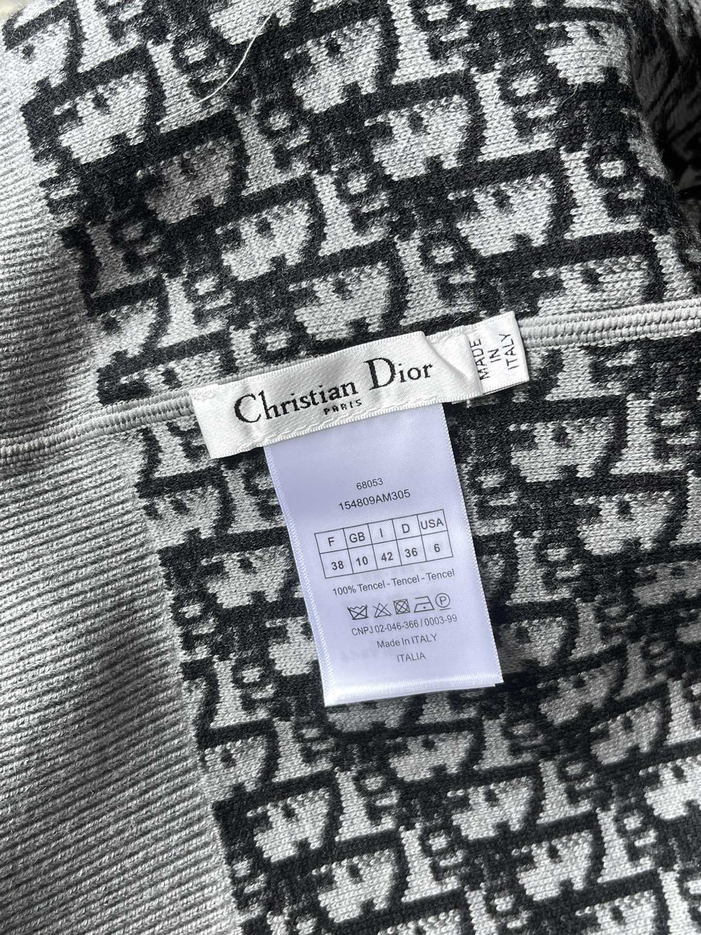 Inside neck tag with “Christian Dior” text and size/care label on patterned knit