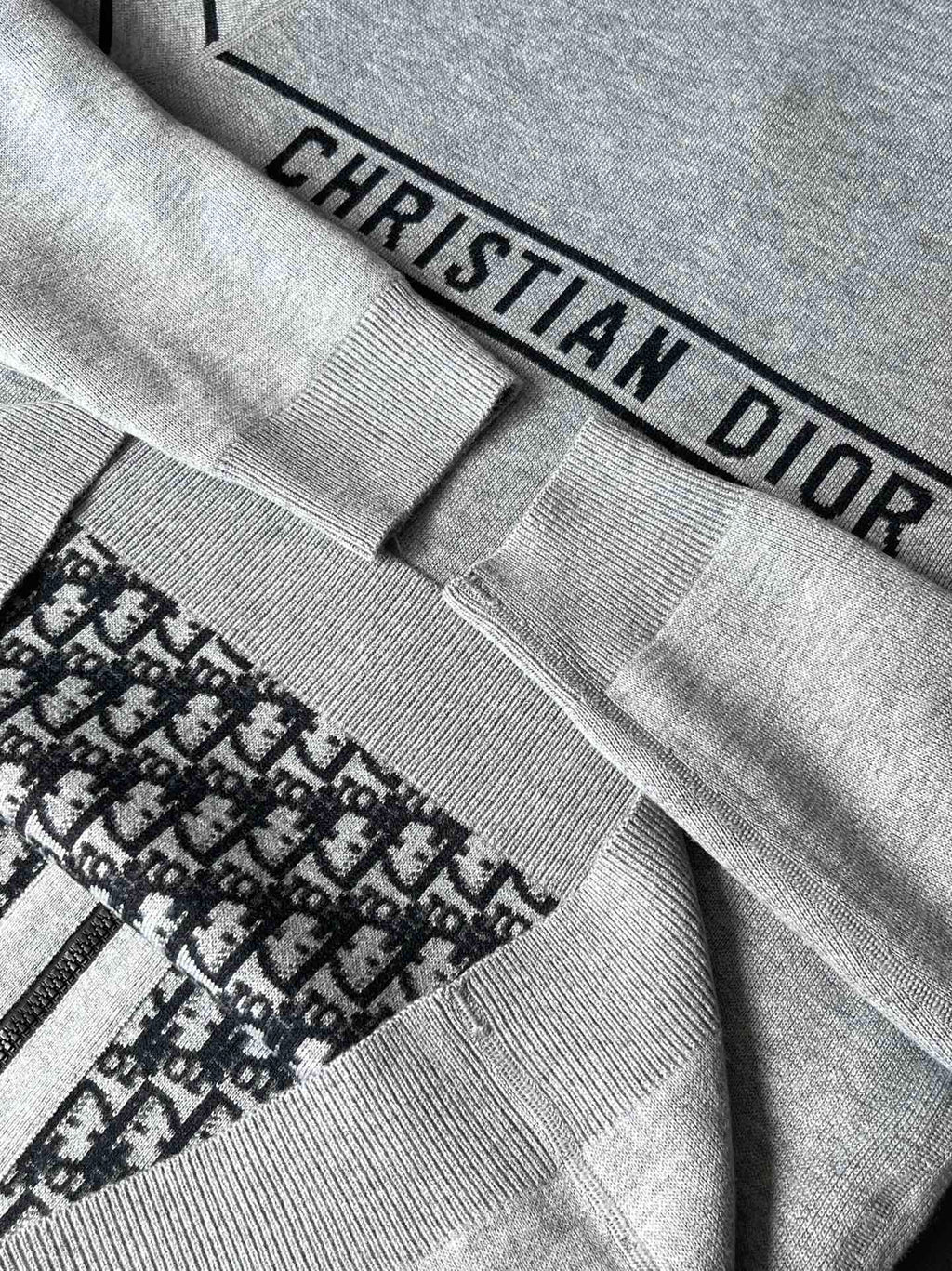 Gray fabric cuff with “CHRISTIAN DIOR” label and ribbed knit trim