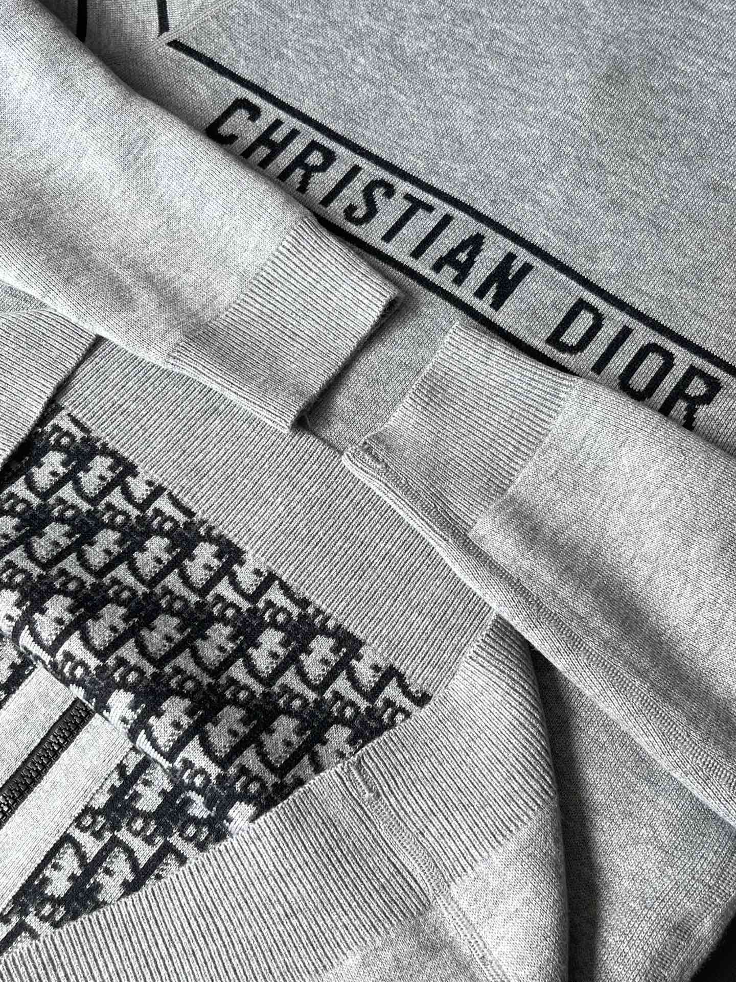 Gray fabric cuff with “CHRISTIAN DIOR” label and ribbed knit trim