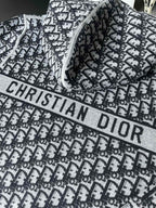 Black and white patterned hooded zip-up sweater with large “CHRISTIAN DIOR” print
