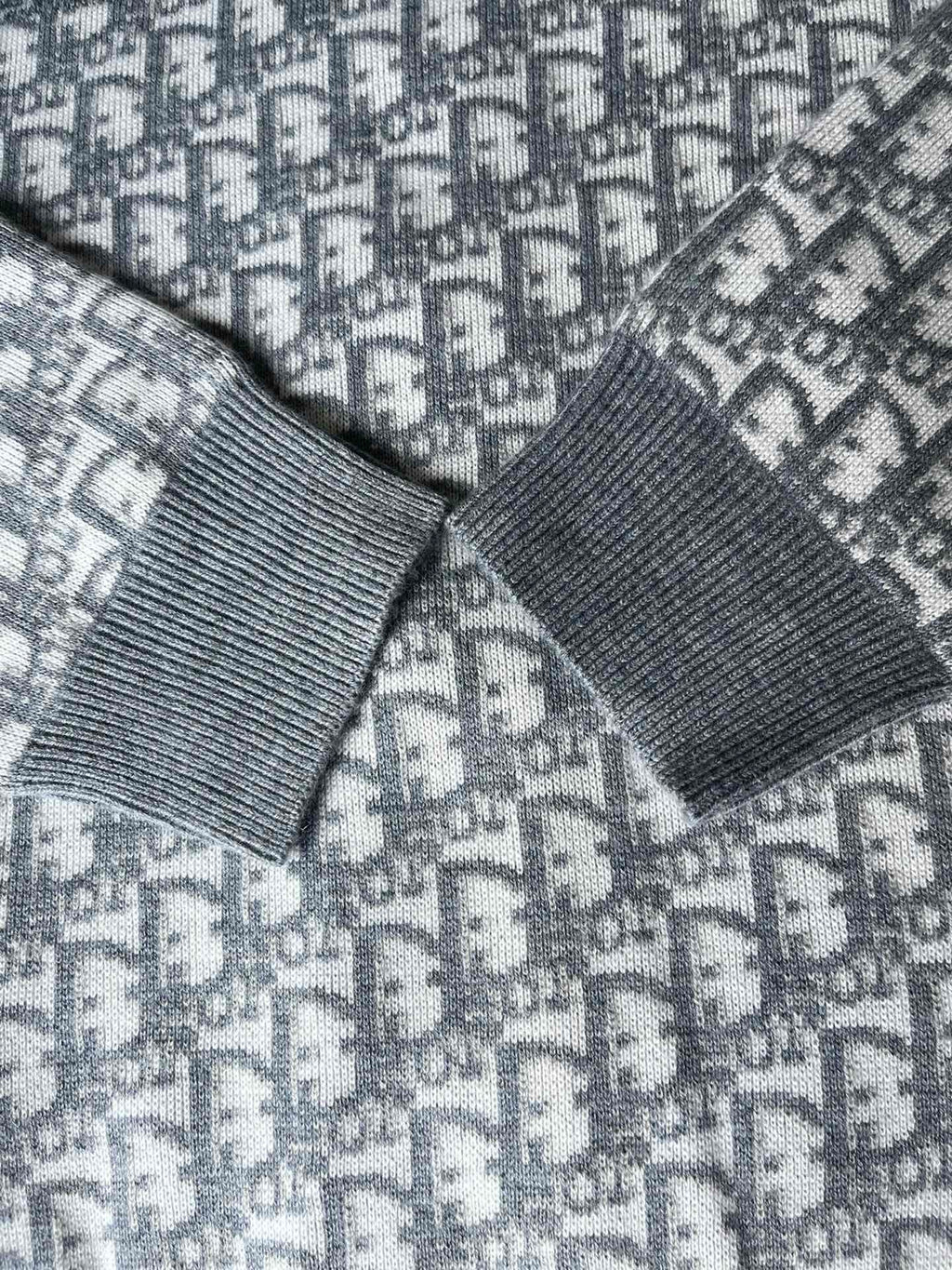 Dior long hooded zip jacket close-up: ribbed cuffs and patterned knit panels