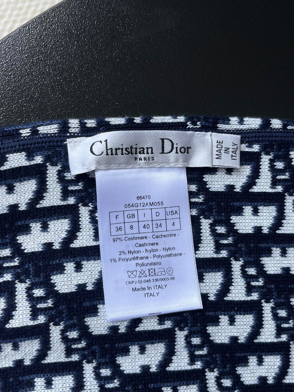 Dior knit sweater size and care label on navy jacquard fabric