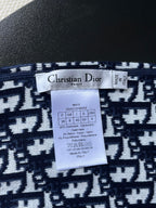 Dior knit sweater size and care label on navy jacquard fabric
