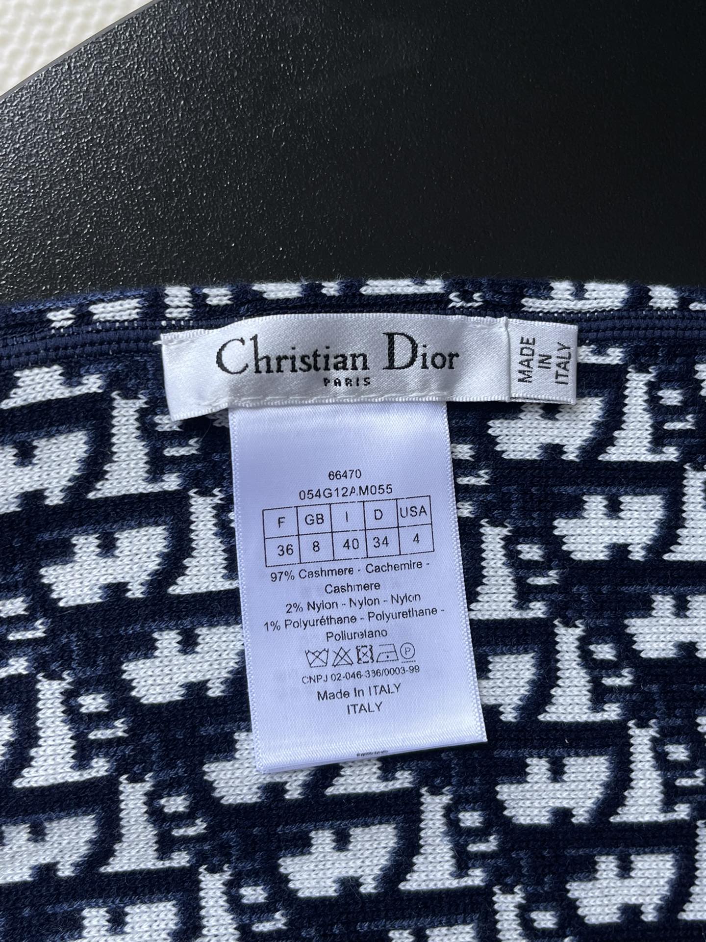 Dior knit sweater size and care label on navy jacquard fabric